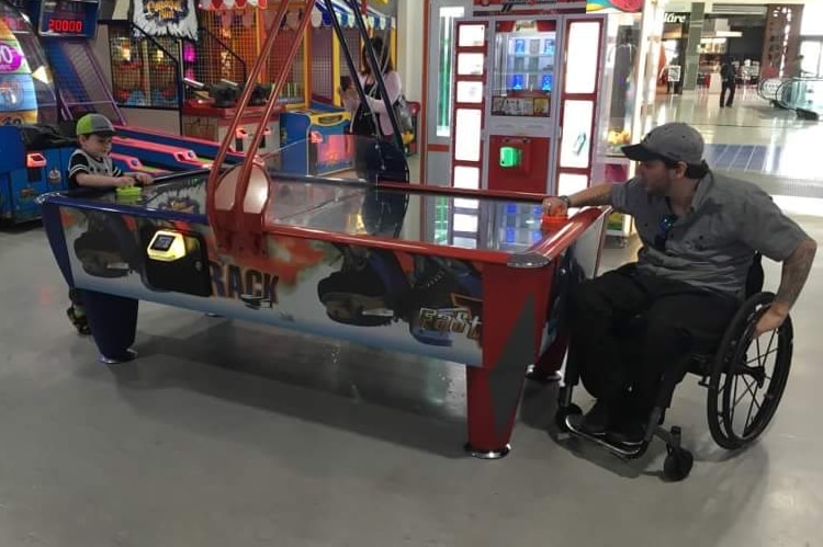 Like any father, Australian wheelchair rugby player Jake Howe is in his element playing games with his son.