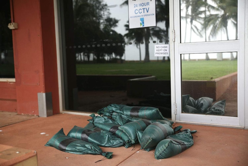 Sandbags sitting outside a glass office door.