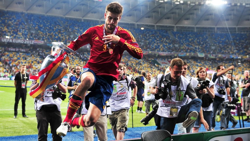 Spain’s Gerard Piqué celebrates with the trophy after his team's win in the Euro 2012 final