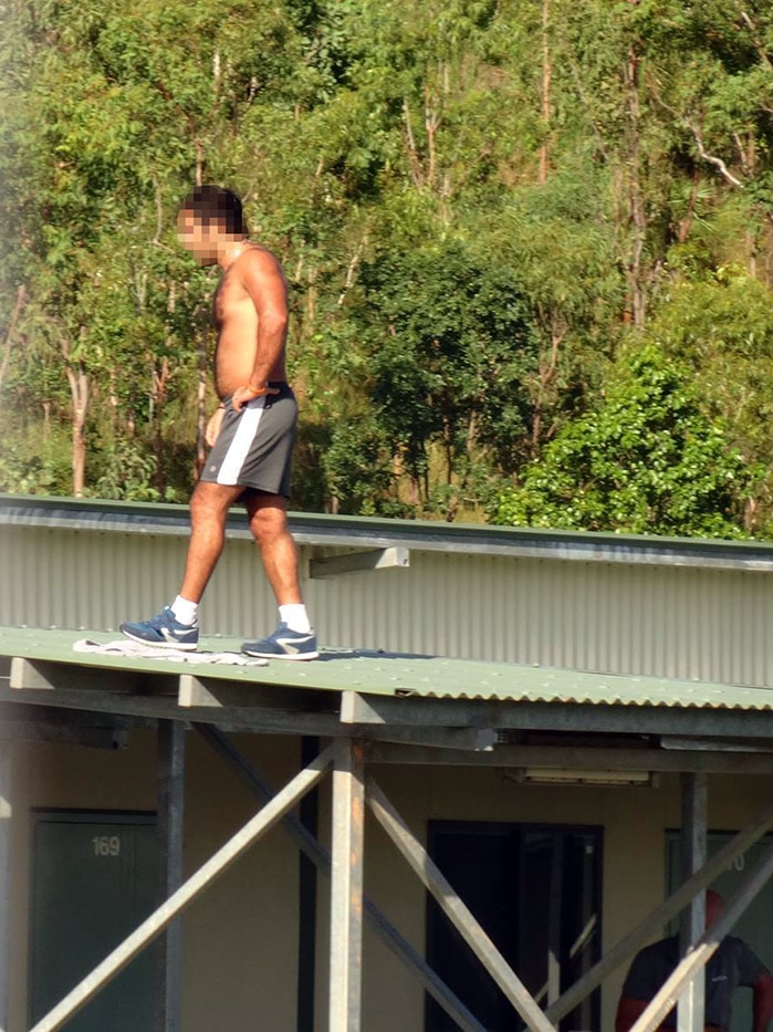 This image believed to be from inside the detention centre shows a man walking on a roof
