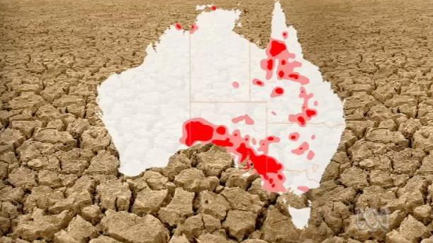 A map of Australia indicating zones of drought, superimposed over very cracked earth