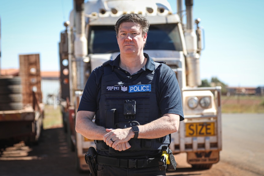 A WA police officer in a dark blue uniform. 