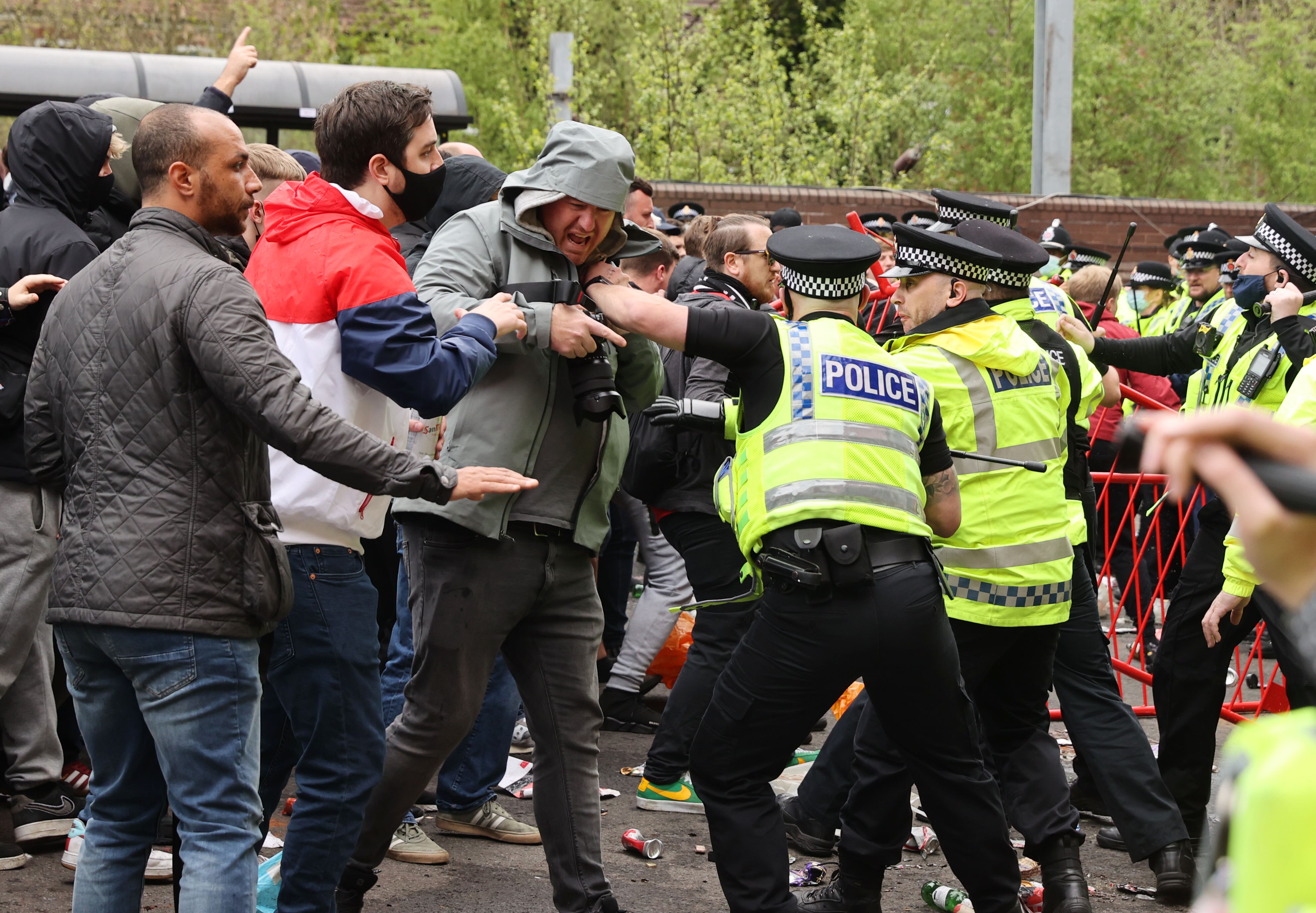 Police hold back protesters Old Trafford