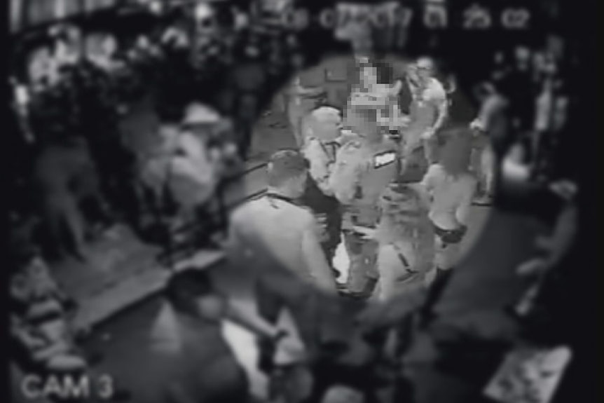 A policeman speaks closely with a patron at Inflation Nightclub in Melbourne.