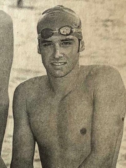 Black and white photo of a young swimmer from an old newspaper.