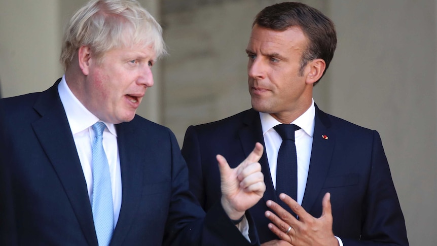 French President Emmanuel Macron and Britain's Prime Minister Boris Johnson gesture