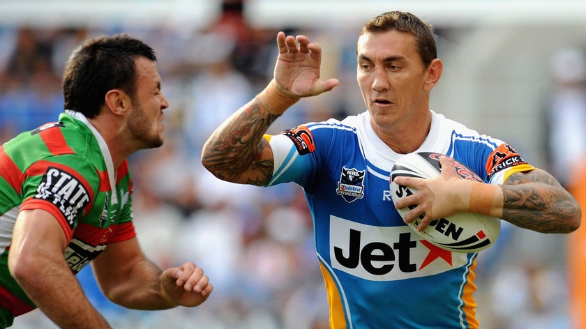 Mat Rogers fends off the South Sydney defence