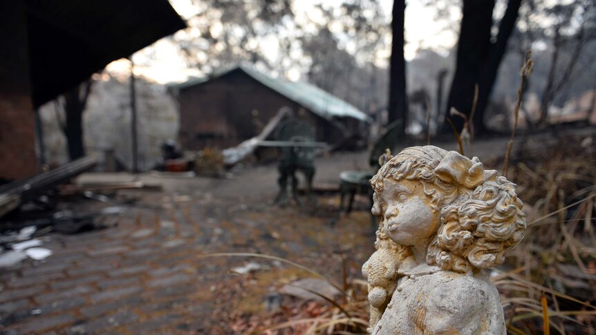 Statue outside bushfire damaged home