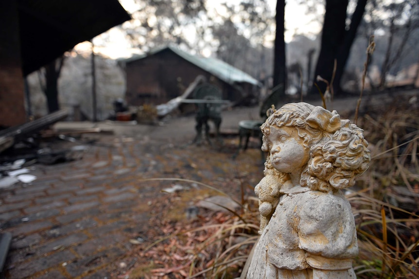 Statue outside bushfire damaged home