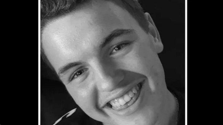 Black and white photo of a young man smiling