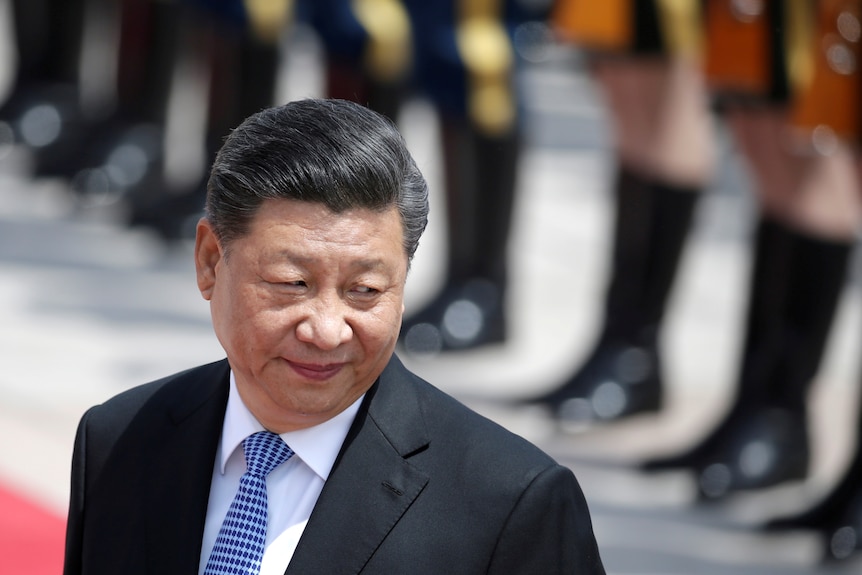 Xi Jinping with a slight smile on his face 