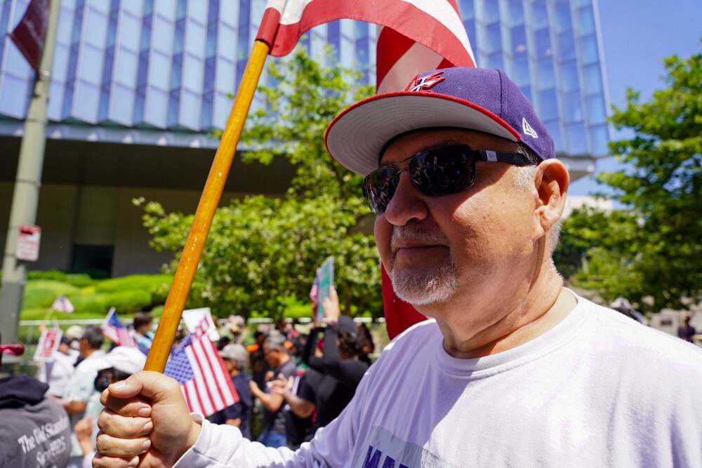 Protesters hold signs in the streets of Los Angeles' downtown area.