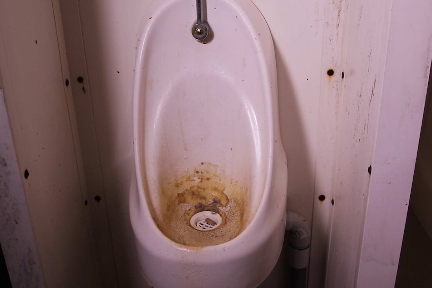 A dirty urinal inside the the facility