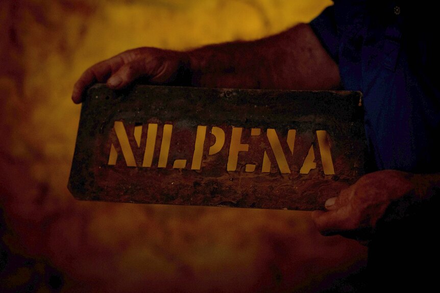 A stencil of the word "Nilpena".