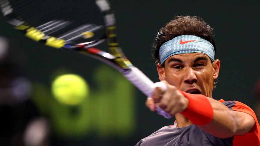 Spain's Rafael Nadal returns the ball to Czech Republic's Lukas Rosol at the Qatar Open.