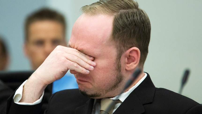 Breivik sheds a tear as the court views a propaganda film he made.