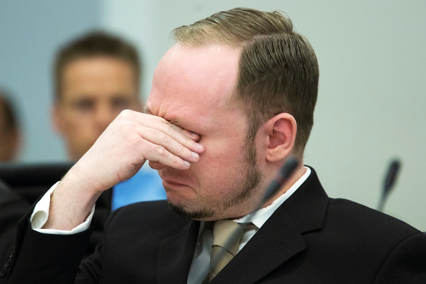 Breivik sheds a tear as the court views a propaganda film he made.