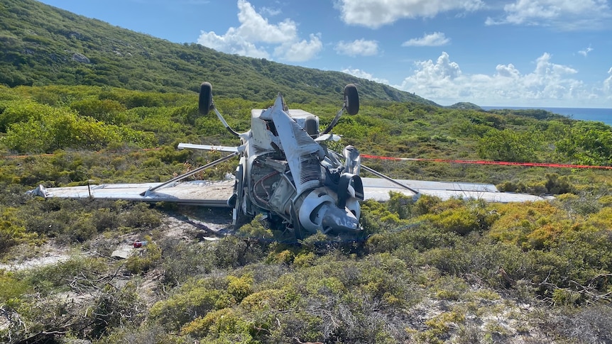 A plane rests upside down after crashing.