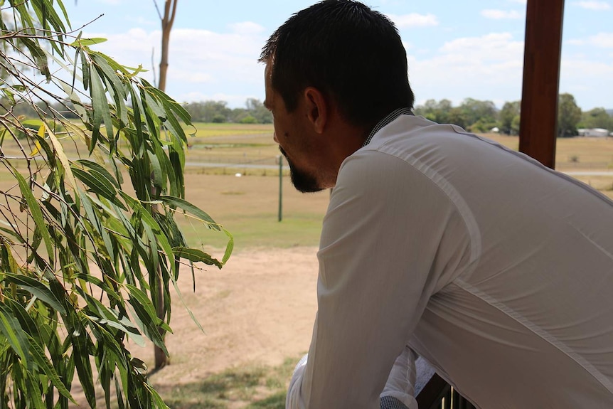 Back of head photo to protect identity of recovering drug addict 'Ben' leaning on a verandah rail.