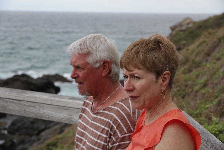 Side-profile photo of Lyn and Pete Turner, sitting outside, with the beach in the background.