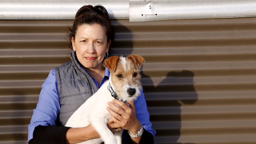 Tammy Ven Dange holds a dog.