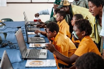 School students use laptops.