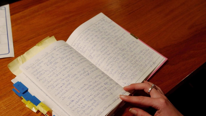 A woman's hands on an open diary