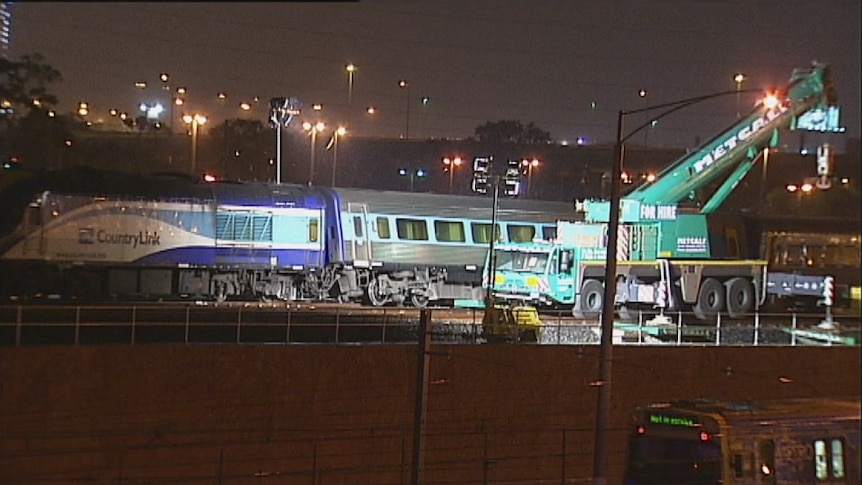 Efforts to remove a train derailed in Melbourne have been hampered by rain.
