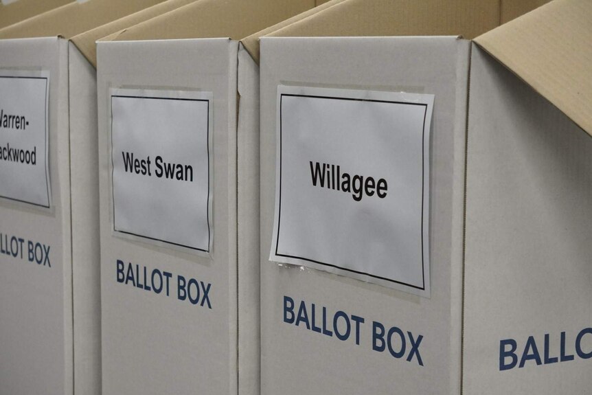 A close-up photo of a row of empty ballot boxes.