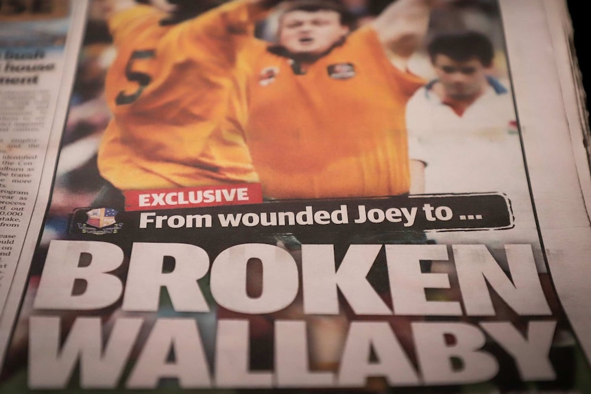 A still of a newspaper article with the headline 'From wounded joey to broken Wallaby'.