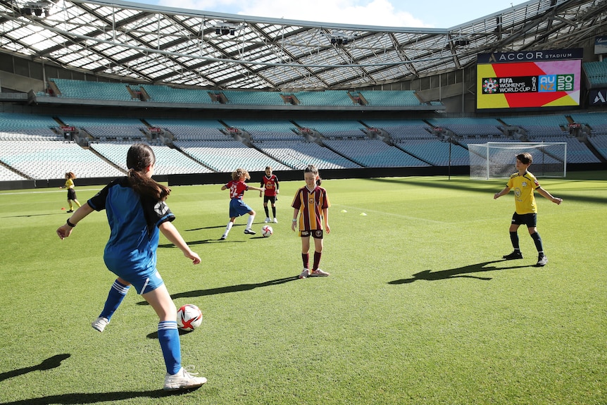 Kids play soccer inside a major stadium