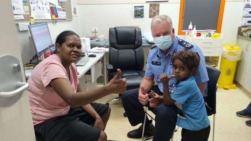 Gary Dreibergs with an Indigenous woman and a little boy in a vaccination room