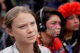 Sixteen year-old Swedish climate activist Greta Thunberg listens to speakers during a climate change demonstration.