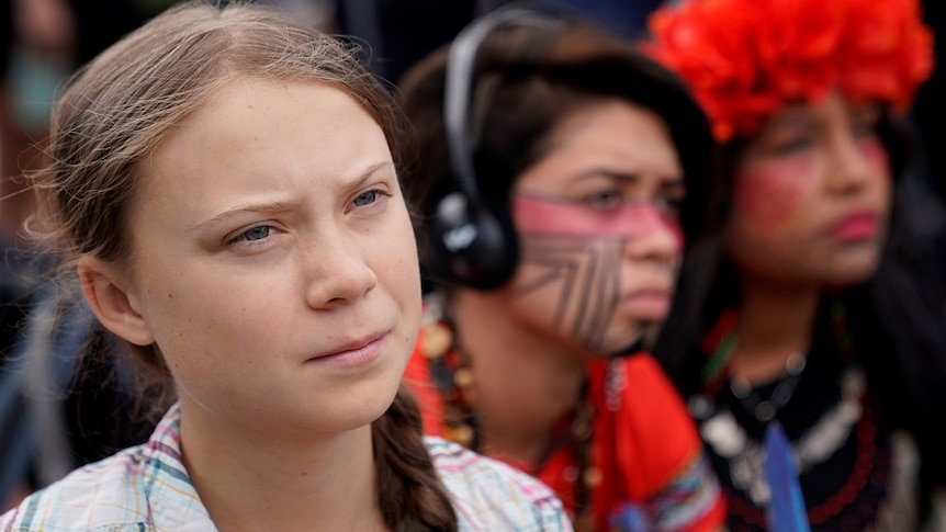 Sixteen year-old Swedish climate activist Greta Thunberg listens to speakers during a climate change demonstration.