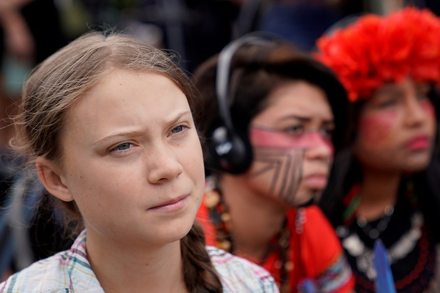 Sixteen year-old Swedish climate activist Greta Thunberg listens to speakers during a climate change demonstration.