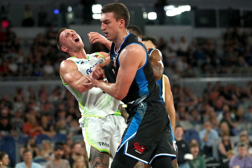 Two NBL players collide during a game.
