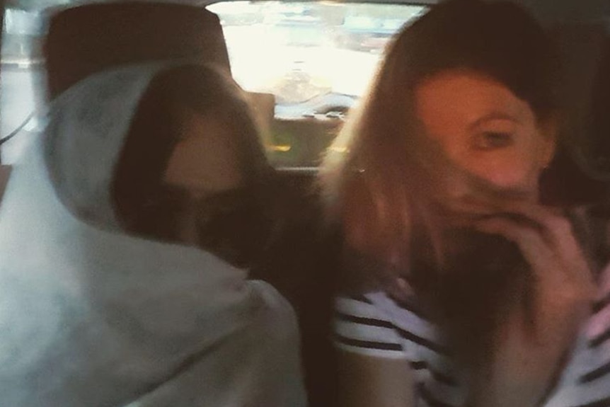Schapelle and Mercedes Corby covering their faces in the car on their way to the airport in Bali  May 27, 2017.