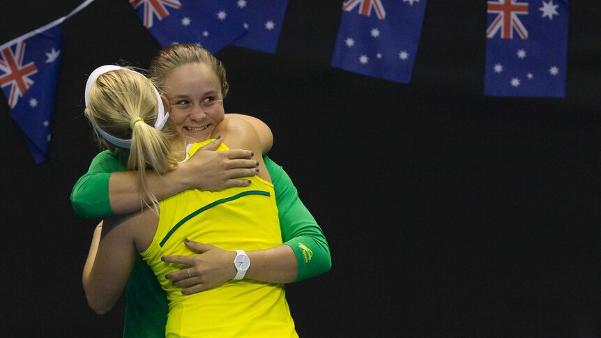 Australia's Daria Gavrilova celebrates by hugging Ash Barty after defeating Netherlands in Fed Cup.