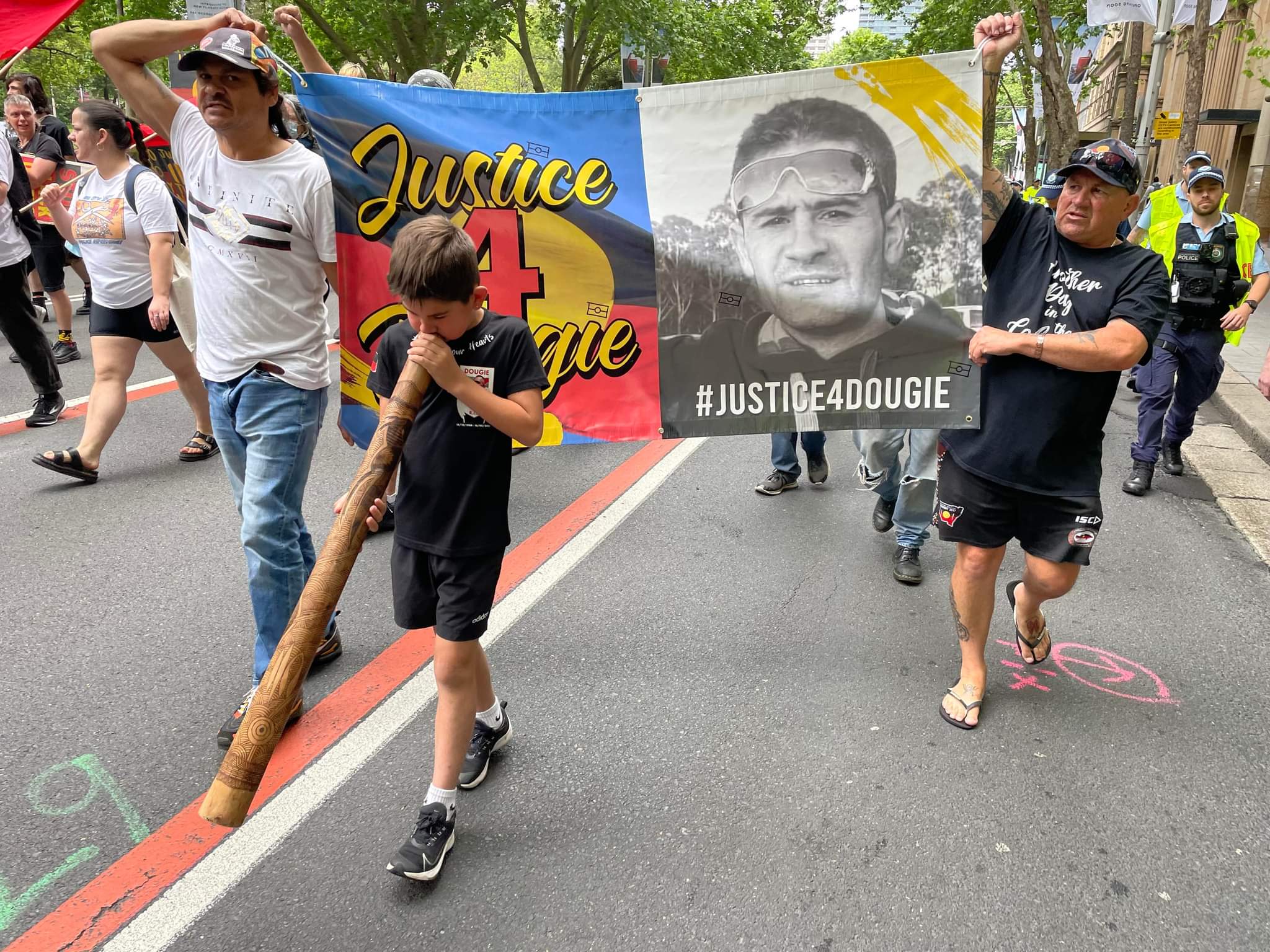 A march with a banner "Justice 4 Dougie".