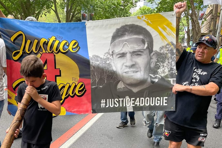 A march with a banner "Justice 4 Dougie".