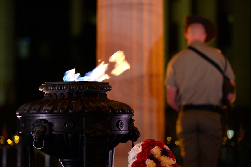 The eternal flame burns during an Anzac Day dawn service at the Cenotaph in Brisbane.