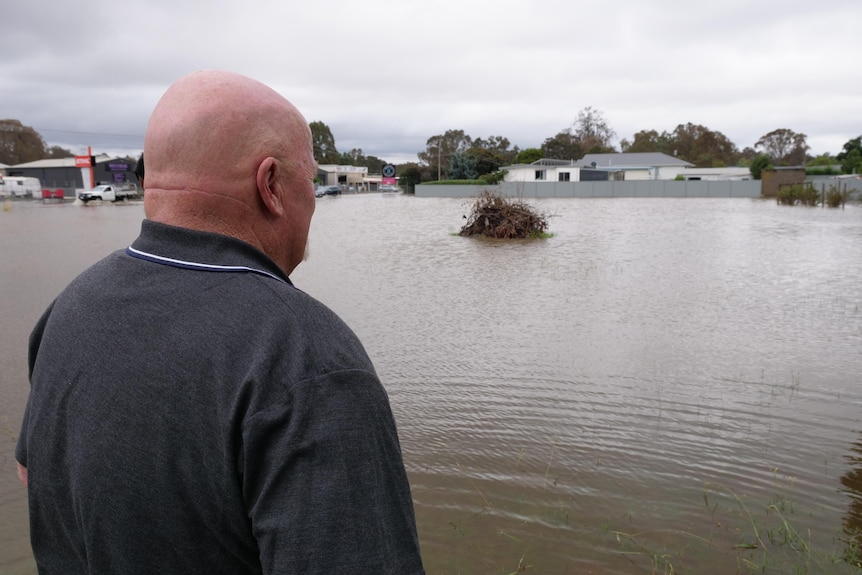 A man staring out at some flooding 