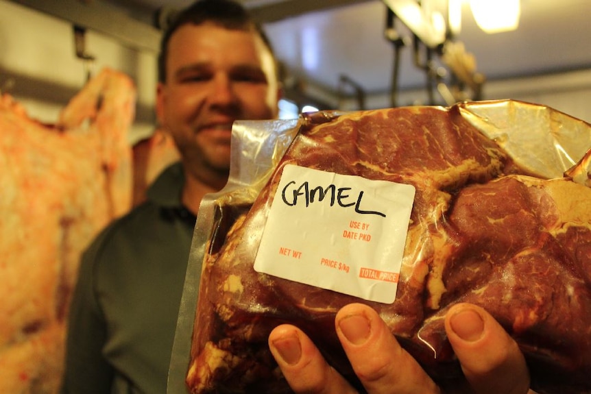 Keegan Nelson holds camel meat