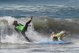 Surf dog Kona Kai and owner Shaun Lucado compete in the tandem event
