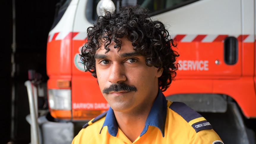 An Aboriginal man with a mustache and curly hair.