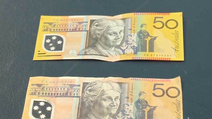 A counterfeit $50 note pictured under a genuine note. Found at Yeppoon, Queensland