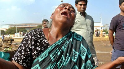An Indian woman wails after her house was damaged near the Marina beach at Chennai.