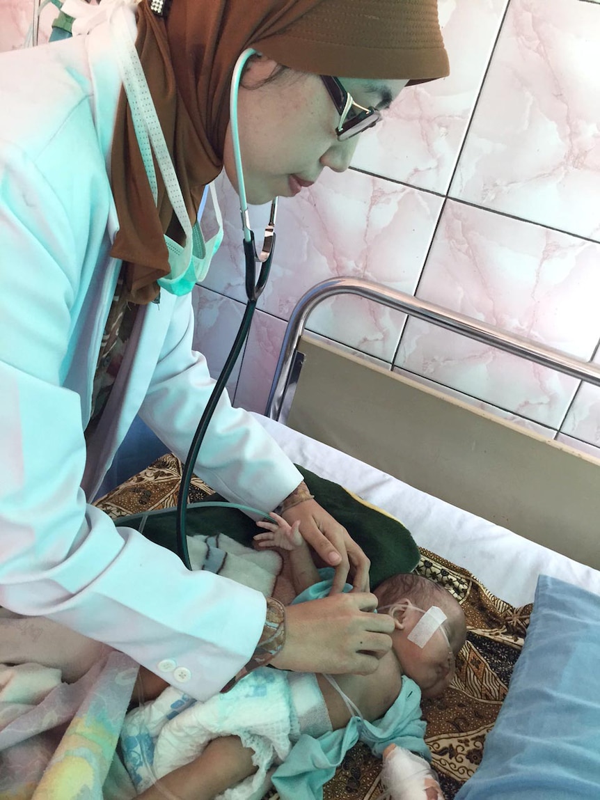 Dr Citra Raditha Zein treats three-month-old Aulia, who has smoke-related pneumonia.