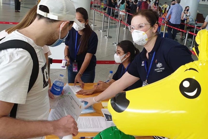 Australians prepare to get on a flight out of Cambodia, which has been locked down due to the coronavirus pandemic.