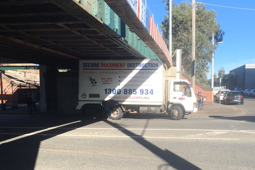 A truck wedged under the Montague Street rail bridge